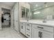 Double vanity bathroom with modern white cabinets at 18610 W Alice Ave, Waddell, AZ 85355