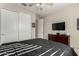 Bedroom with large closet and mounted TV at 18610 W Alice Ave, Waddell, AZ 85355