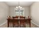 Bright dining area with wood table and chairs and window with plantation shutters at 18610 W Alice Ave, Waddell, AZ 85355