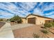 Single story home with brown garage door and landscaping at 18610 W Alice Ave, Waddell, AZ 85355