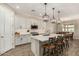 Modern kitchen featuring white cabinets, island, and stainless steel appliances at 18610 W Alice Ave, Waddell, AZ 85355