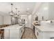 Modern kitchen with white cabinets, island, and stainless steel appliances at 18610 W Alice Ave, Waddell, AZ 85355