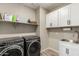 Laundry room with washer, dryer, and utility sink at 18610 W Alice Ave, Waddell, AZ 85355