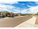 Quiet residential street with single-Gathering homes and mountain views at 18610 W Alice Ave, Waddell, AZ 85355