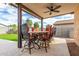 Covered patio with dining table and ceiling fan at 18610 W Alice Ave, Waddell, AZ 85355