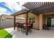 Outdoor dining area with pergola and string lights at 18610 W Alice Ave, Waddell, AZ 85355