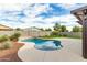 Enjoy this kidney shaped pool with a waterfall feature at 18610 W Alice Ave, Waddell, AZ 85355