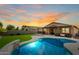 Stunning sunset view over the backyard pool and patio at 18610 W Alice Ave, Waddell, AZ 85355