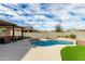 Lovely kidney shaped pool with grassy area at 18610 W Alice Ave, Waddell, AZ 85355