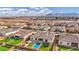 Wide aerial view of neighborhood with manicured landscaping and a pool, patio and trampoline in the backyard at 20456 E Camina Buena Vis, Queen Creek, AZ 85142