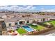 An aerial view of the backyard showcasing a pool, trampoline, fire pit, and mountain views at 20456 E Camina Buena Vis, Queen Creek, AZ 85142