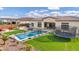 Spacious backyard with a pool, trampoline, outdoor seating area, and lush landscaping at 20456 E Camina Buena Vis, Queen Creek, AZ 85142