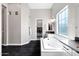 Bathroom featuring a tub, black floors, and an open closet at 20456 E Camina Buena Vis, Queen Creek, AZ 85142