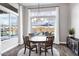 Cozy dining room with backyard views, round table, stylish chandelier and decorative rug at 20456 E Camina Buena Vis, Queen Creek, AZ 85142