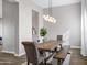 Neutral dining room with a wooden table, bench seating, and modern light fixture at 20456 E Camina Buena Vis, Queen Creek, AZ 85142