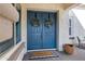 Beautiful double door with black hardware and wreaths, welcomes you home at 20456 E Camina Buena Vis, Queen Creek, AZ 85142