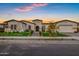 Charming single-story home with well-manicured landscaping, a three-car garage, and a welcoming front entrance at 20456 E Camina Buena Vis, Queen Creek, AZ 85142