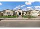 Stunning single-story home with manicured lawn, decorative stone and a welcoming arched entryway at 20456 E Camina Buena Vis, Queen Creek, AZ 85142