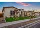 Inviting single-Gathering home featuring lush landscaping and a well-maintained lawn at twilight at 20456 E Camina Buena Vis, Queen Creek, AZ 85142