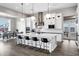 Modern kitchen with a large white island, stainless steel appliances, and bar stool seating at 20456 E Camina Buena Vis, Queen Creek, AZ 85142