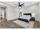 Bright main bedroom featuring wood floors, a rug, and a king bed with bench at 20456 E Camina Buena Vis, Queen Creek, AZ 85142