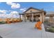 Exterior view of outdoor kitchen and seating with orange adirondack chairs at 20456 E Camina Buena Vis, Queen Creek, AZ 85142