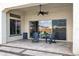 Covered patio with ceiling fan and sliding doors to the backyard at 20456 E Camina Buena Vis, Queen Creek, AZ 85142