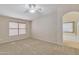 Main bedroom with plush carpet, window blinds and access to bathroom at 20902 N 36Th Pl, Phoenix, AZ 85050