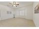 Neutral bedroom with tile flooring, ceiling fan, and bay windows with white shutters allowing in lots of light at 23114 N 146Th Dr, Sun City West, AZ 85375