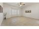 Neutral bedroom with tile flooring, ceiling fan, and bay windows with white shutters allowing in lots of light at 23114 N 146Th Dr, Sun City West, AZ 85375