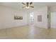 Neutral bedroom with tile flooring, ceiling fan, and bay windows with white shutters allowing in lots of light at 23114 N 146Th Dr, Sun City West, AZ 85375