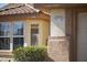 Close up of exterior wall featuring the house address, bushes and windows at 23114 N 146Th Dr, Sun City West, AZ 85375