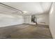 Large open garage with concrete floor, white walls, and utility shelving at 23114 N 146Th Dr, Sun City West, AZ 85375