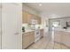 Bright kitchen showcases white appliances, light wood cabinetry, and tiled floor at 23114 N 146Th Dr, Sun City West, AZ 85375