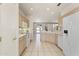 Open concept kitchen with white appliances and light wood cabinets offering a seamless flow to the dining area at 23114 N 146Th Dr, Sun City West, AZ 85375