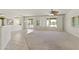 This is the living room with white paint, neutral carpet and tile flooring. It has sliding door access to the outside at 23114 N 146Th Dr, Sun City West, AZ 85375