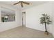 Cozy living room featuring ceiling fan, view of the kitchen and tiled floor at 23114 N 146Th Dr, Sun City West, AZ 85375