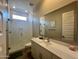 Contemporary bathroom featuring a glass-enclosed shower, a modern vanity with a white countertop at 23448 N 76Th Pl, Scottsdale, AZ 85255