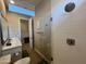 Modern bathroom with glass enclosed shower, and a sleek vanity with a view to an adjacent room at 23448 N 76Th Pl, Scottsdale, AZ 85255