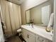 Bathroom vanity with large mirror, white cabinets, and modern faucet at 23448 N 76Th Pl, Scottsdale, AZ 85255