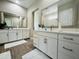 Bright bathroom featuring double sink vanity with modern fixtures and a large mirror at 23448 N 76Th Pl, Scottsdale, AZ 85255