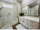 Modern bathroom featuring a glass-enclosed shower, double vanity with white cabinets, and stylish fixtures at 23448 N 76Th Pl, Scottsdale, AZ 85255