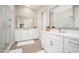 Bathroom featuring double vanity sinks and a glass-enclosed shower at 23448 N 76Th Pl, Scottsdale, AZ 85255