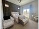 A serene main bedroom with stylish wall decor, natural light, and a cozy seating area at 23448 N 76Th Pl, Scottsdale, AZ 85255