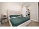 Comfortable bedroom with closet with sliding door, upholstered headboard, side tables, and ensuite laundry at 23448 N 76Th Pl, Scottsdale, AZ 85255