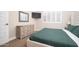 Cozy bedroom with natural light, wood dresser, television, carpet flooring, and stylish decor at 23448 N 76Th Pl, Scottsdale, AZ 85255
