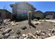 Lush front yard showcasing desert landscaping, including a large cactus, rocks, and other vegetation with stone accents at 23448 N 76Th Pl, Scottsdale, AZ 85255