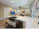 Open kitchen with large island, stainless steel sink, and seamless flow into the living area at 23448 N 76Th Pl, Scottsdale, AZ 85255