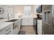 Contemporary kitchen with white cabinets, stainless steel sink, and modern appliances at 23448 N 76Th Pl, Scottsdale, AZ 85255