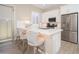 Bright kitchen featuring a breakfast bar, stainless steel appliances, and ample counter space at 23448 N 76Th Pl, Scottsdale, AZ 85255